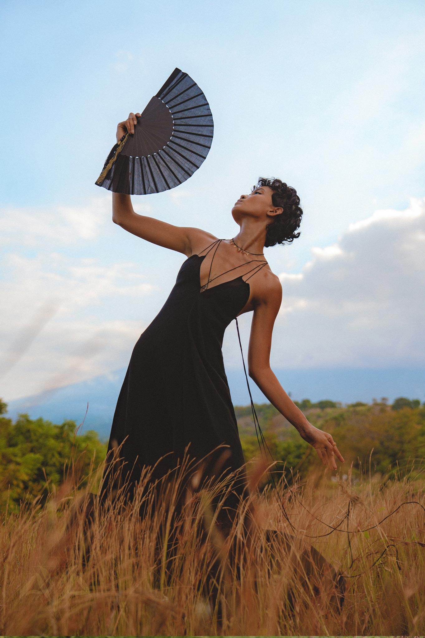Step into the spotlight with this stunning black goddess dress. Its boho and backless style, coupled with minimalist features, make it a true standout piece.