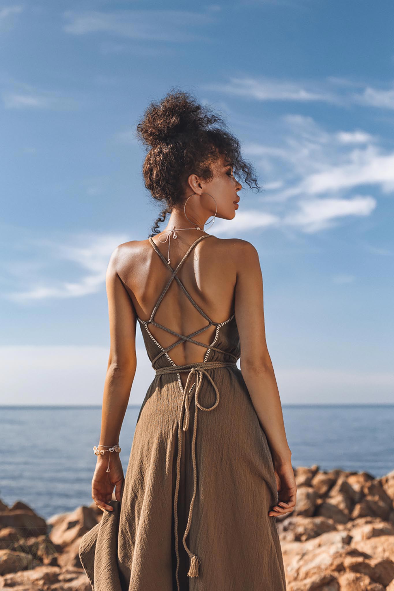 This dark green organic cotton maxi dress is sleeveless and hand embroidered. It has a V-neckline and a full skirt. It is perfect for a summer day or night.