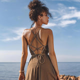 This dark green organic cotton maxi dress is sleeveless and hand embroidered. It has a V-neckline and a full skirt. It is perfect for a summer day or night.