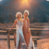 Airy sleeveless beige ochre dress with intricate embroidery and open sides.