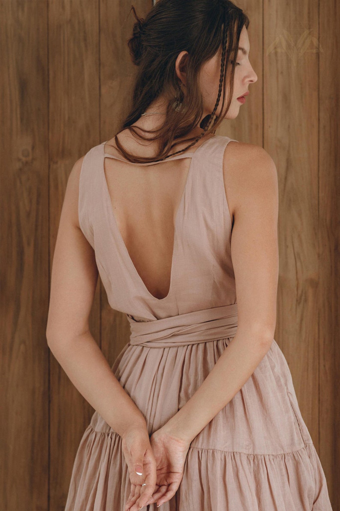 A woman in an AYA Sacred Wear Boho Mini Bridesmaid Dress in dusty pink.