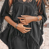 A person wearing a bohemian top from AYA Sacred Wear stands outdoors, exuding a boho vibe. Their hands are crossed in front of them, and their curly hair cascades over their shoulders. The blurred natural background complements the look beautifully.