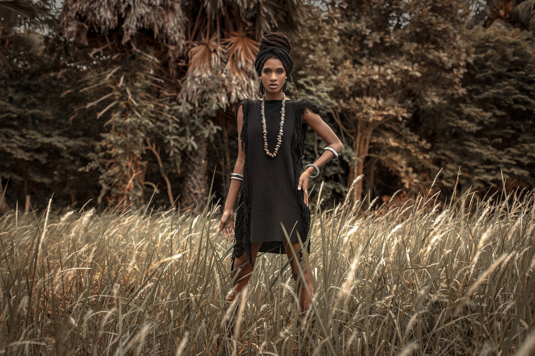 Stay cool and stylish in this black mini dress with ladder cut-outs and open sides.