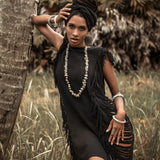 The perfect summer mini dress, this black number features open sides and ladders.