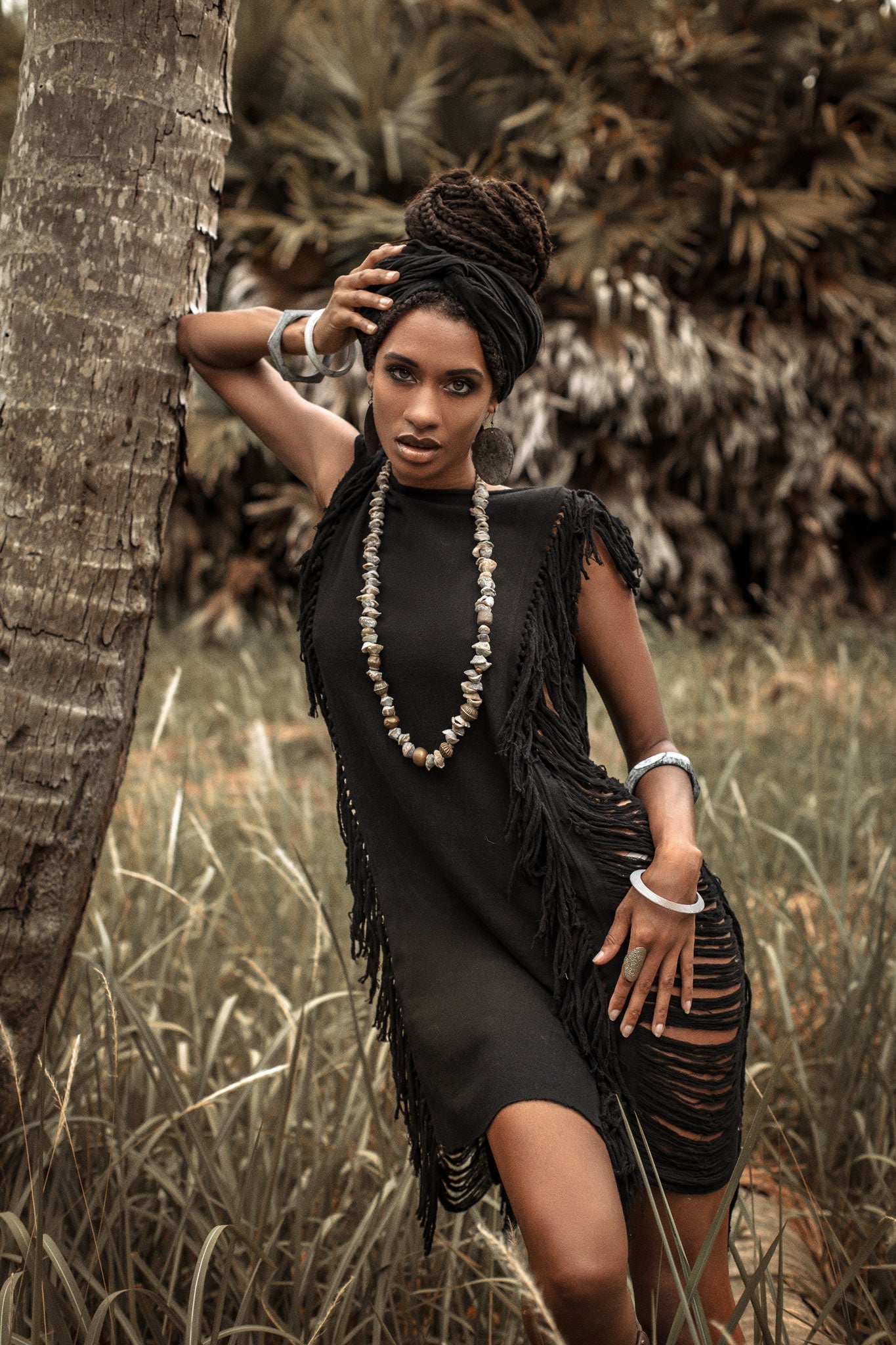 The perfect summer mini dress, this black number features open sides and ladders.