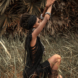 Show some skin in this sultry black mini dress with ladder cut-outs.