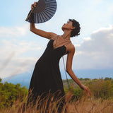 Step into the spotlight with this stunning black goddess dress. Its boho and backless style, coupled with minimalist features, make it a true standout piece.