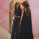 Show off your unique style with the one-of-a-kind black cape dress from Aya Sacred Wear.