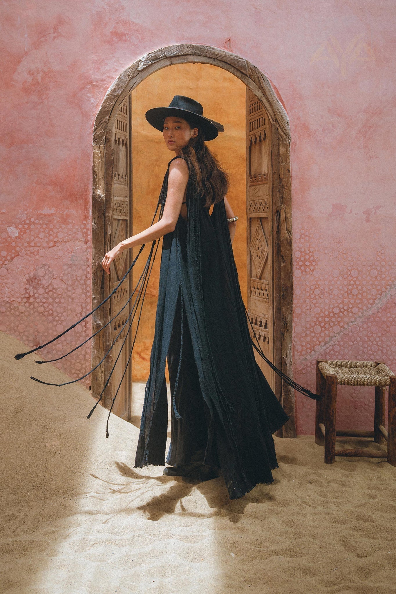 Look like a queen in the sophisticated black cape dress by Aya Sacred Wear.