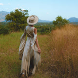 Elevate your style with this elegant silk dress in a light sage shade. Ideal for wedding guests, this exquisite bohemian dress boasts a wrap kimono design and beautiful bell sleeves.