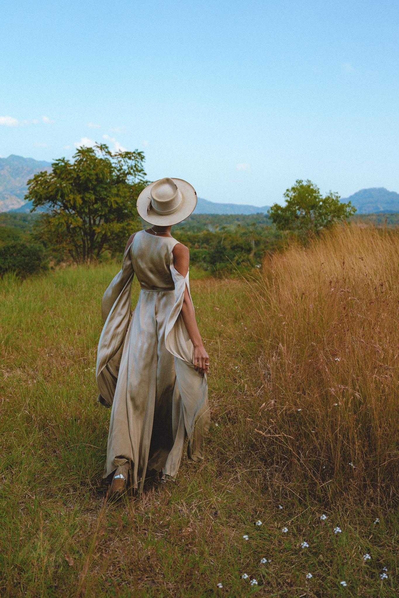 Elevate your style with this elegant silk dress in a light sage shade. Ideal for wedding guests, this exquisite bohemian dress boasts a wrap kimono design and beautiful bell sleeves.