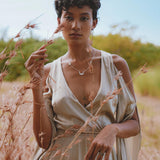 This exquisite silk dress in a soft sage shade is a dreamy choice for bridesmaids or an enchanted wedding guest. The wrap kimono silhouette and flowing bell sleeves create a bohemian yet sophisticated look.