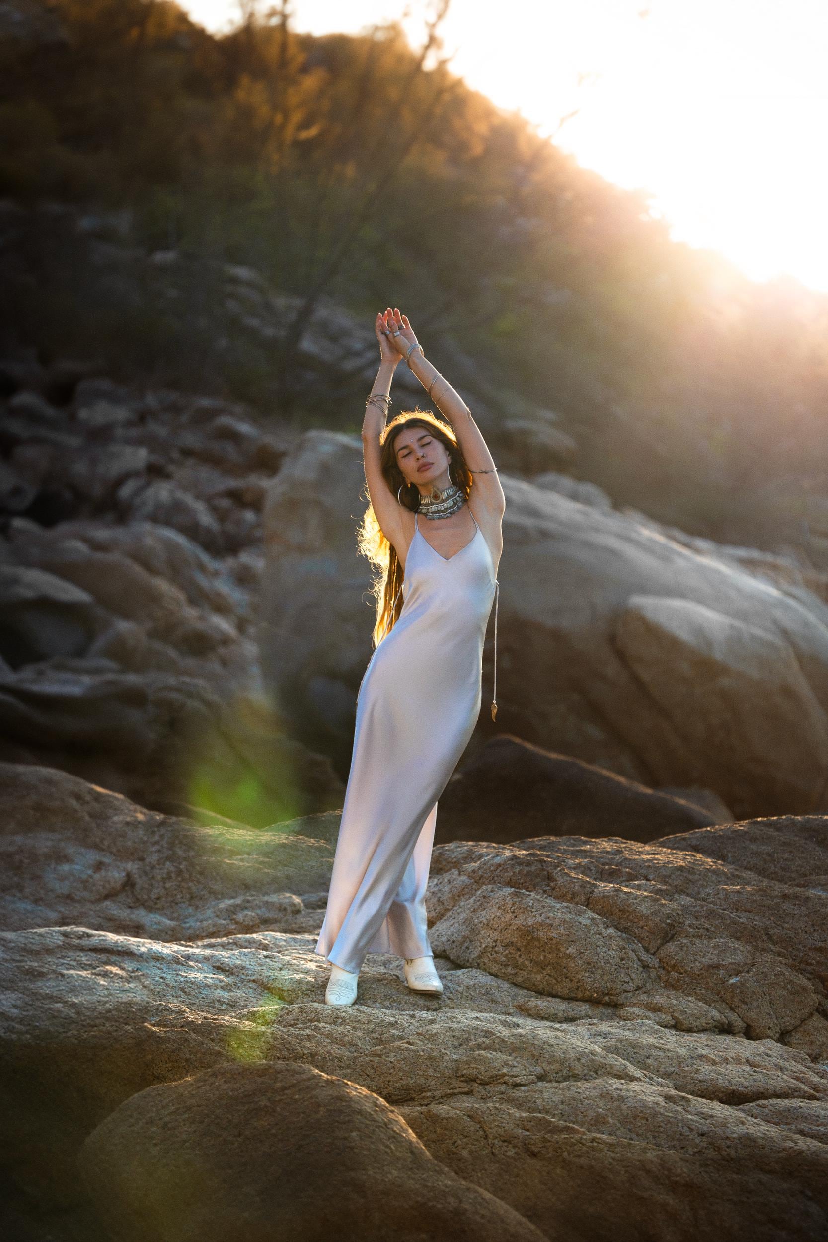 Mist blue peace silk maxi slip dress made from organic Ahimsa silk, soft, breathable, and ethically produced without harming silkworms. This bohemian gown features delicate handmade brass angel wing details and a flowing silhouette that flatters the body. Lightweight and airy, it is perfect for summer, travel, ceremonies, weddings, or everyday luxury wear. Botanically dyed with natural pigments, each dress is unique, sustainable, and designed for comfort, elegance, and timeless feminine style.