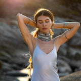 Mist blue peace silk maxi slip dress made from organic Ahimsa silk, soft, breathable, and ethically produced without harming silkworms. This bohemian gown features delicate handmade brass angel wing details and a flowing silhouette that flatters the body. Lightweight and airy, it is perfect for summer, travel, ceremonies, weddings, or everyday luxury wear. Botanically dyed with natural pigments, each dress is unique, sustainable, and designed for comfort, elegance, and timeless feminine style.
