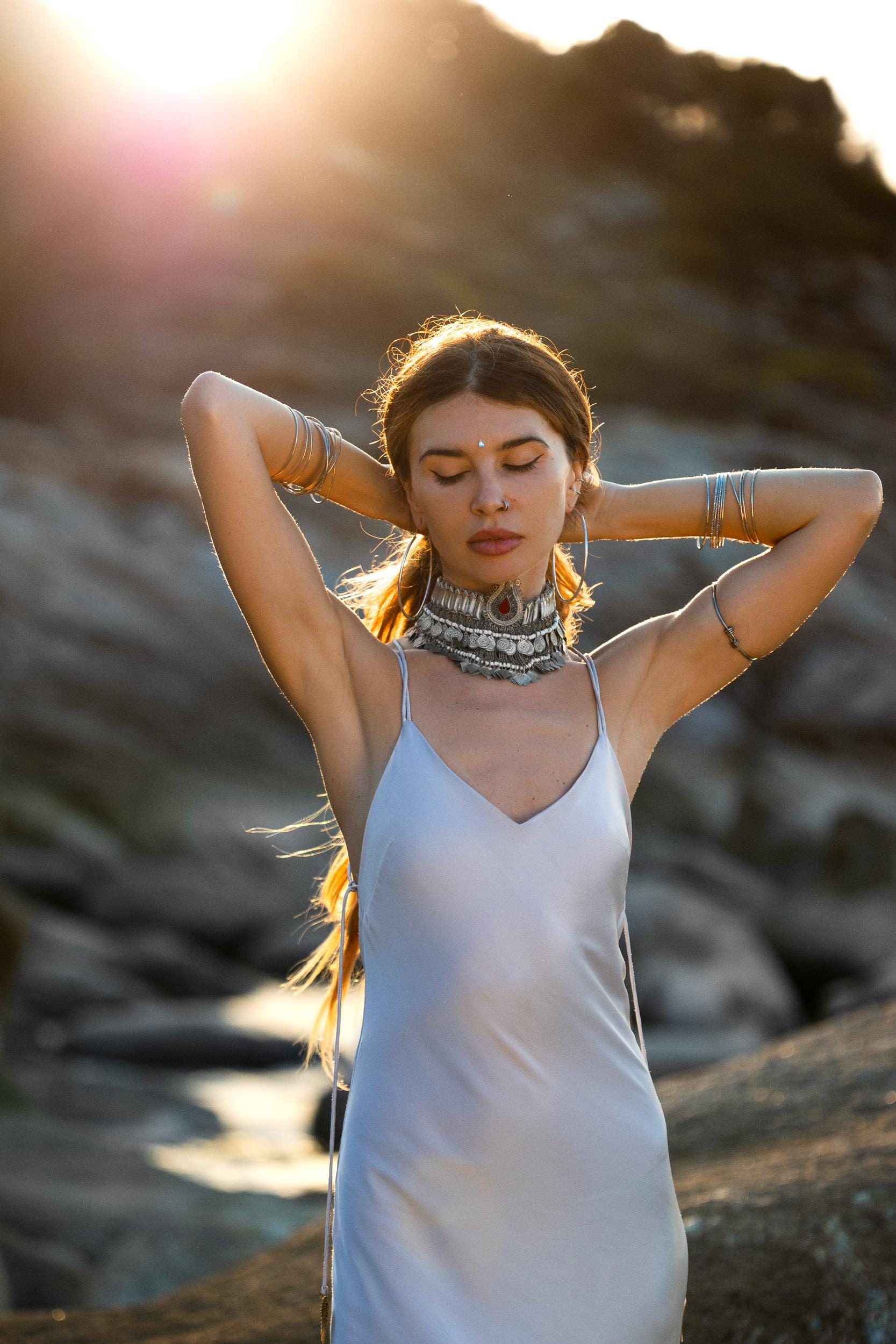 Mist blue peace silk maxi slip dress made from organic Ahimsa silk, soft, breathable, and ethically produced without harming silkworms. This bohemian gown features delicate handmade brass angel wing details and a flowing silhouette that flatters the body. Lightweight and airy, it is perfect for summer, travel, ceremonies, weddings, or everyday luxury wear. Botanically dyed with natural pigments, each dress is unique, sustainable, and designed for comfort, elegance, and timeless feminine style.