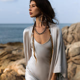 Indulge in the timeless elegance of the Silk Kimono in Mist Blue, a luxurious floor-length robe that combines both style and comfort. Crafted from premium silk, this kimono glides effortlessly over the body, capturing the light with a soft, radiant golden sheen. Its flowing, relaxed silhouette offers an effortlessly chic look, perfect for adding a touch of elegance to any outfit.