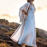 Mist blue peace silk maxi slip dress made from organic Ahimsa silk, soft, breathable, and ethically produced without harming silkworms. This bohemian gown features delicate handmade brass angel wing details and a flowing silhouette that flatters the body. Lightweight and airy, it is perfect for summer, travel, ceremonies, weddings, or everyday luxury wear. Botanically dyed with natural pigments, each dress is unique, sustainable, and designed for comfort, elegance, and timeless feminine style.