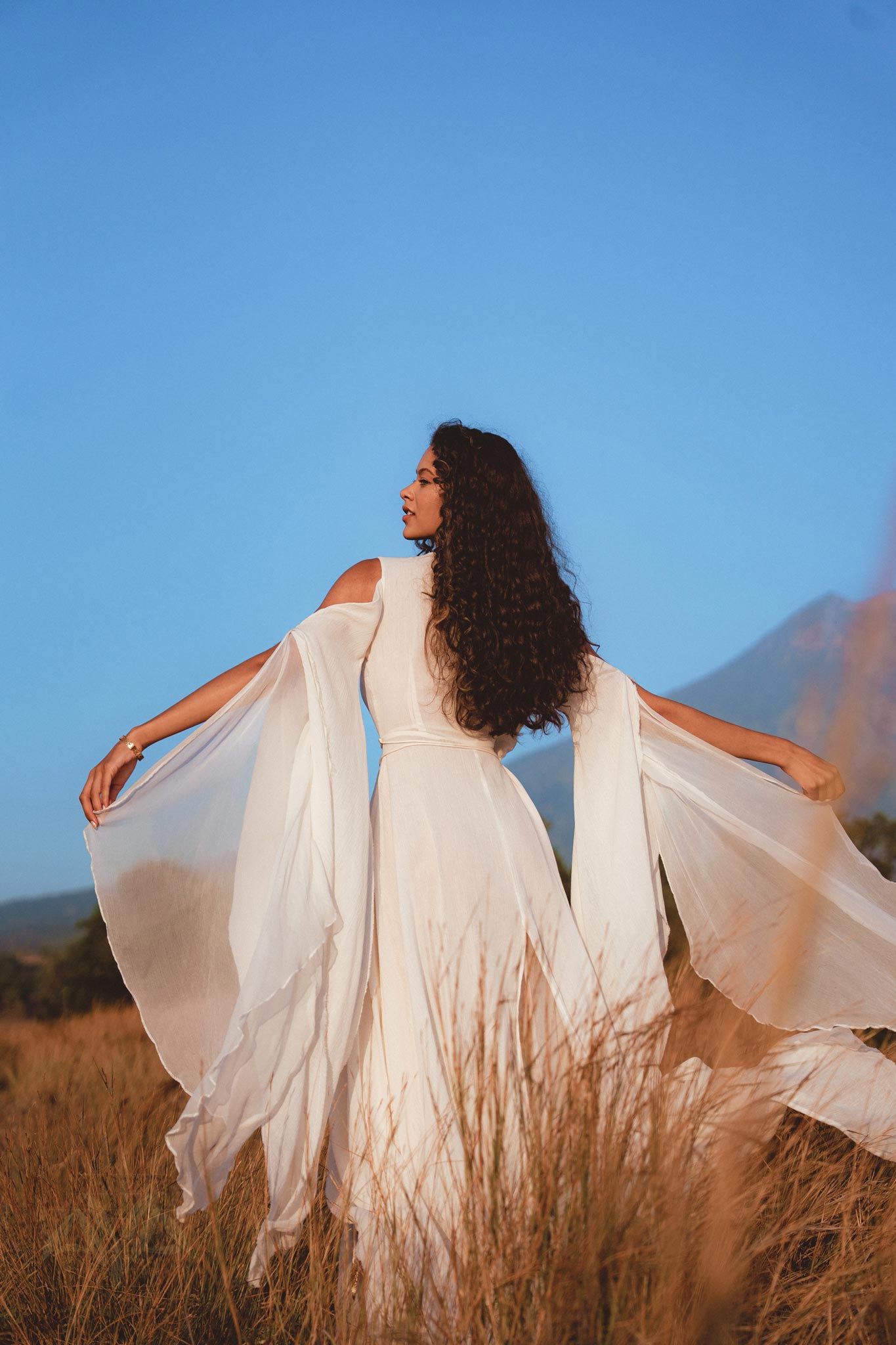 Keep your wedding day eco-friendly with an off-white organic dress from Aya Sacred Wear.