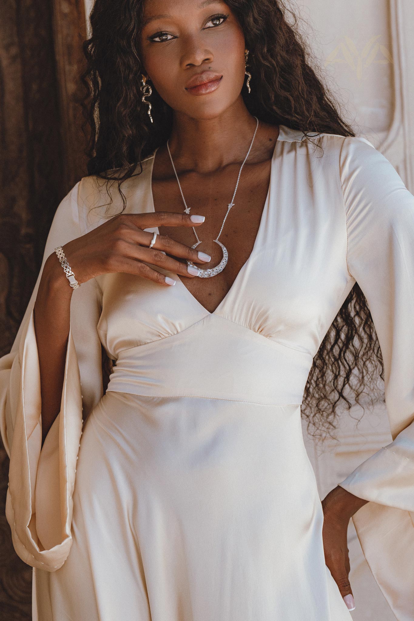 Dreamy cream-colored peace silk dress perfect for the ethereal bride, exuding bohemian charm with its captivating open back and elegant bell sleeves.