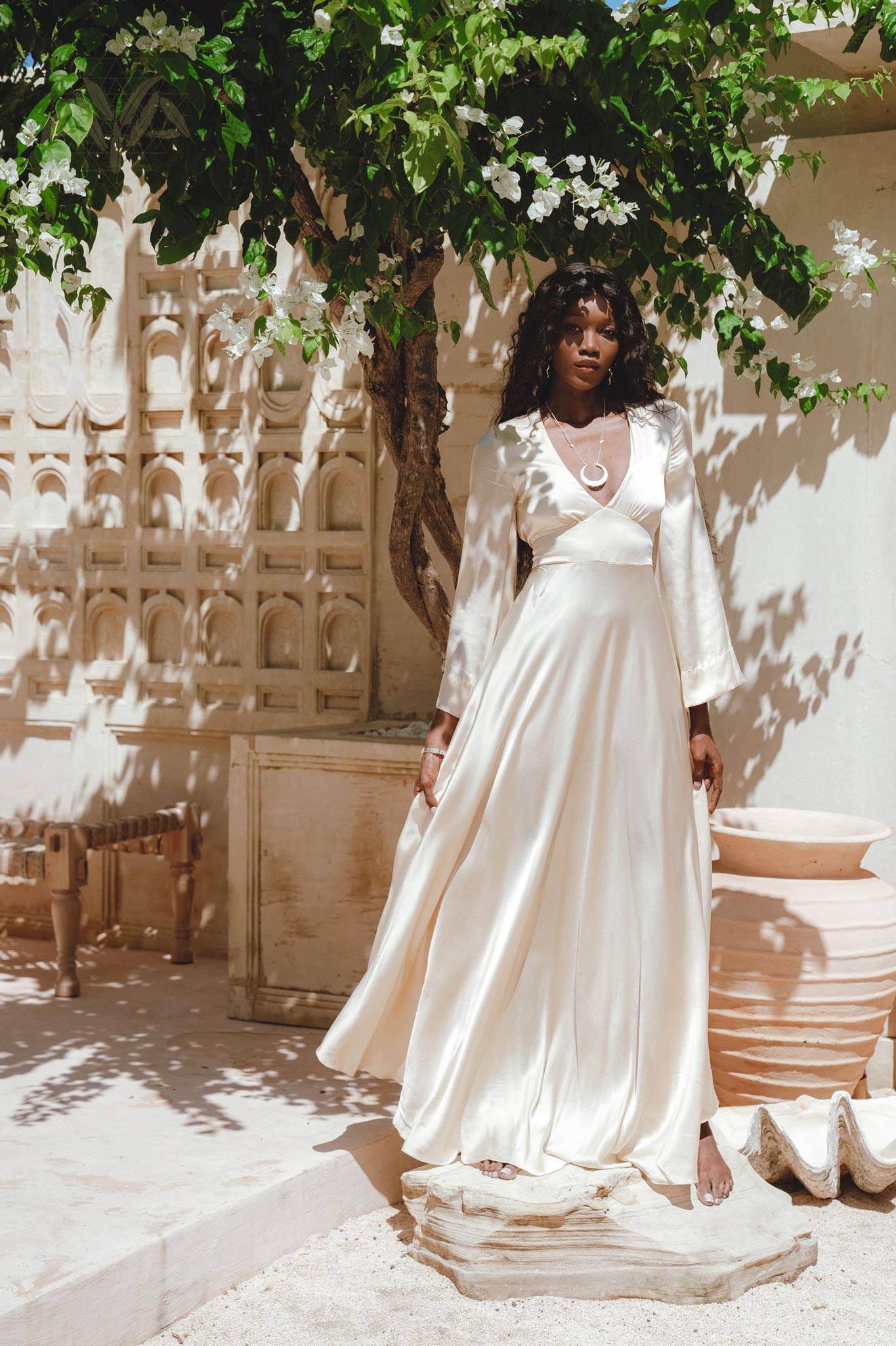 A masterpiece of bohemian fashion, this off-white peace silk dress showcases bold bell sleeves and a captivating open back, making it ideal for formal occasions.