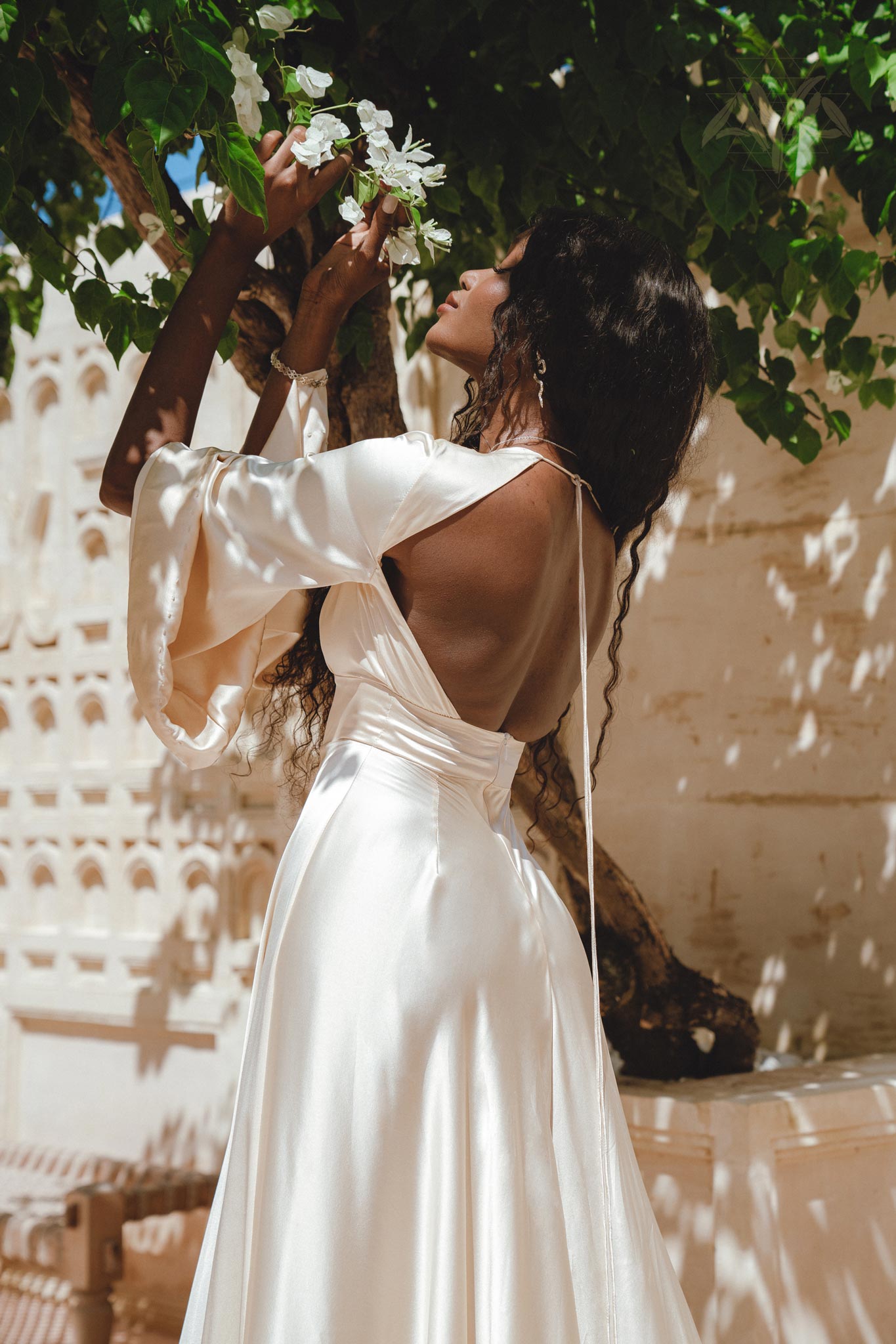 Radiate elegance in this exquisite off-white peace silk maxi dress, boasting a bohemian flair with its enchanting bell sleeves and eye-catching open back.