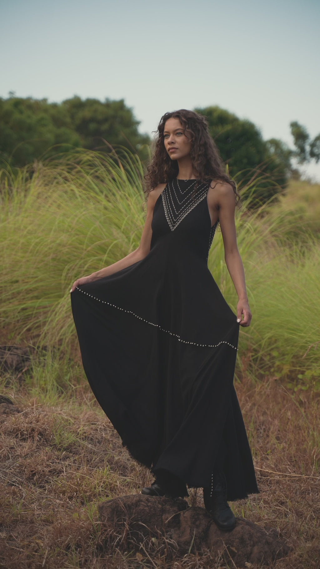 Hand-embroidered Black Goddess Dress, featuring a minimalist boho A-line design. Perfect for cocktails and casual events, crafted from organic materials with delicate ring bell details.