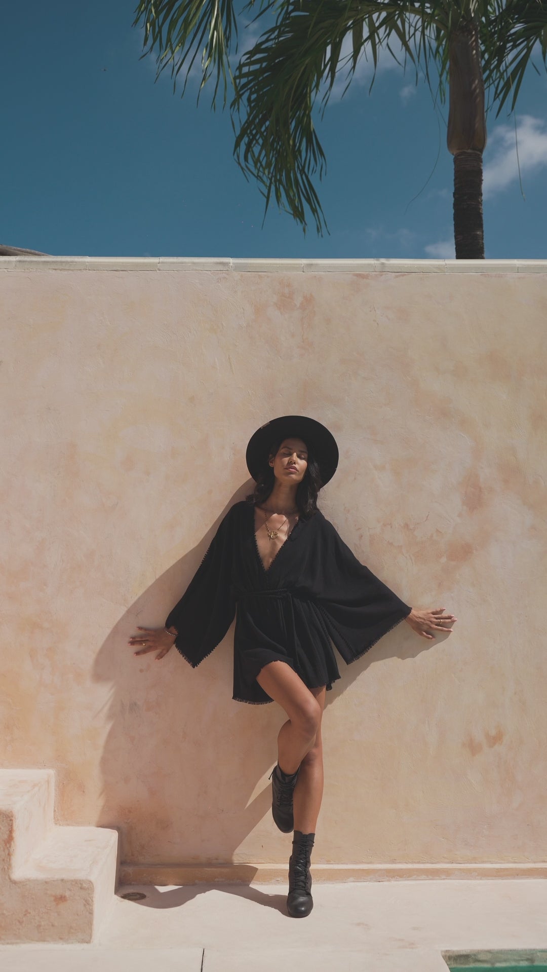 Elegant black mini jumpsuit for women, inspired by Greek goddess style. Perfect as a bohemian beach cocktail romper or a minimalist and sexy boho outfit.