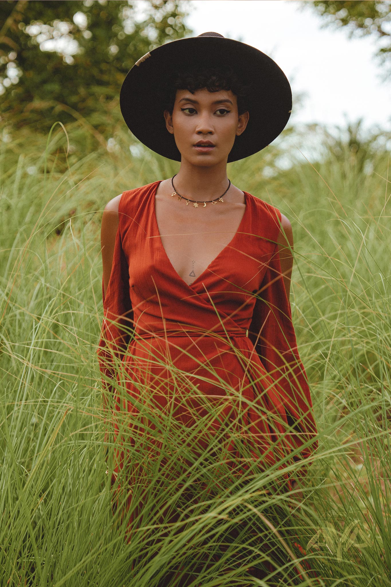 Make a statement as a wedding guest in this red wine boho dress featuring delicate bell sleeves.