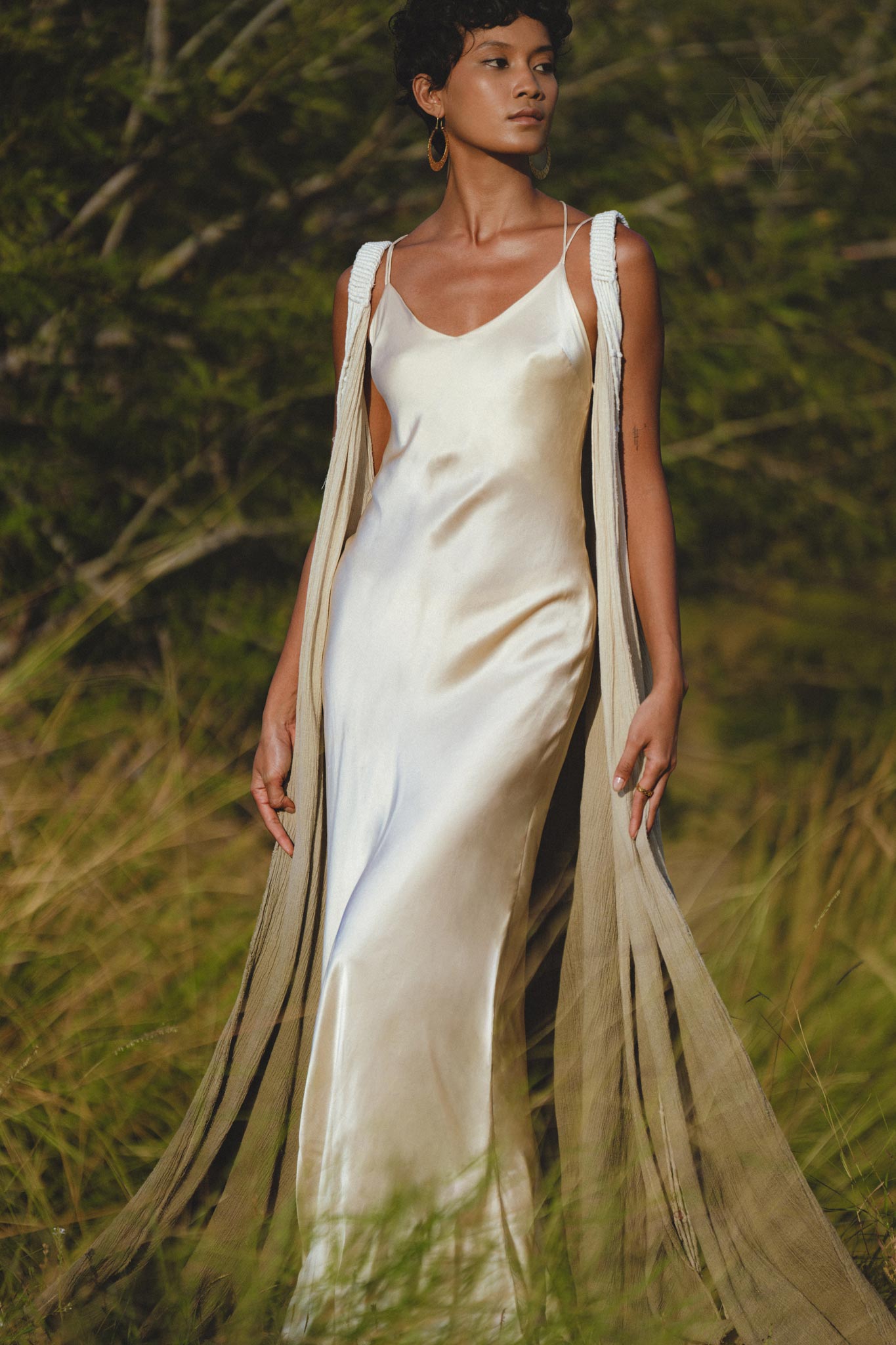 Embrace your inner goddess with this ethereal silk wedding gown in ivory.