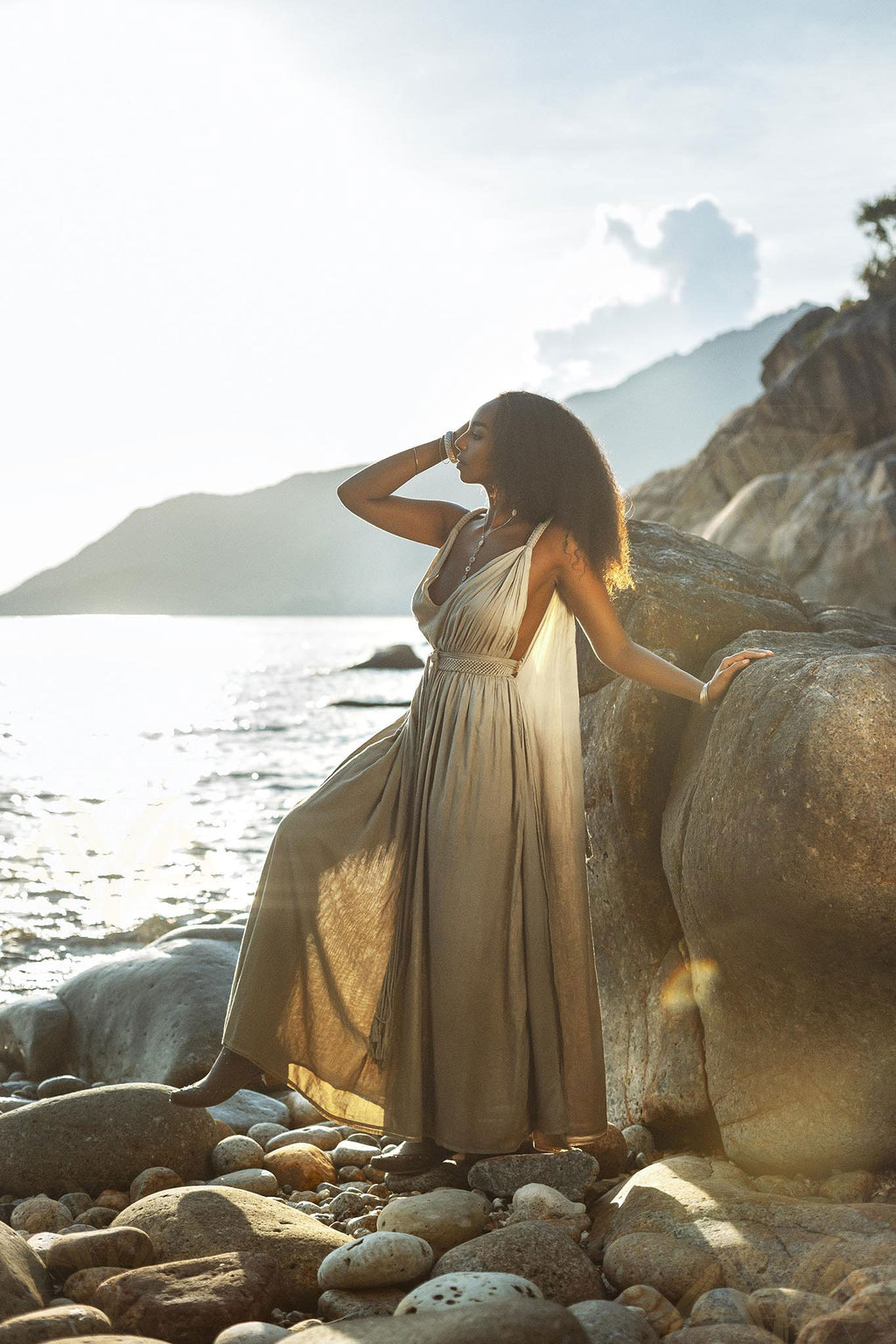 A dark green dress with a flowing silhouette, inspired by Greek goddesses