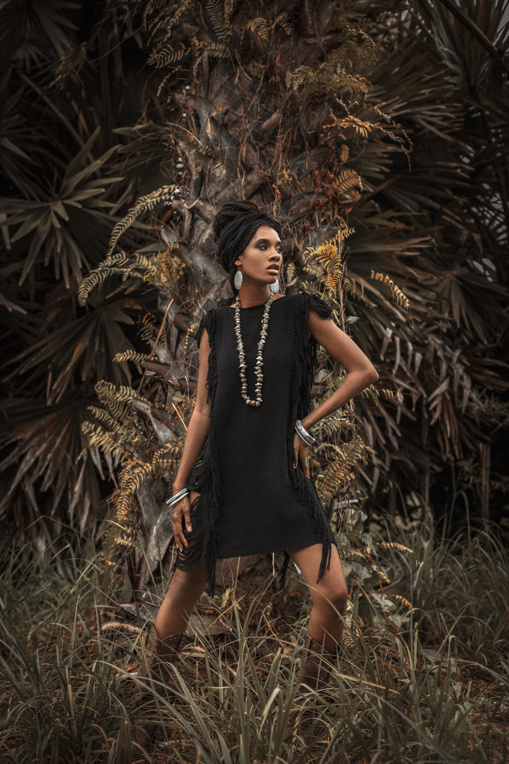 This black mini dress is perfect for a boho-chic look with its open sides and ladders.