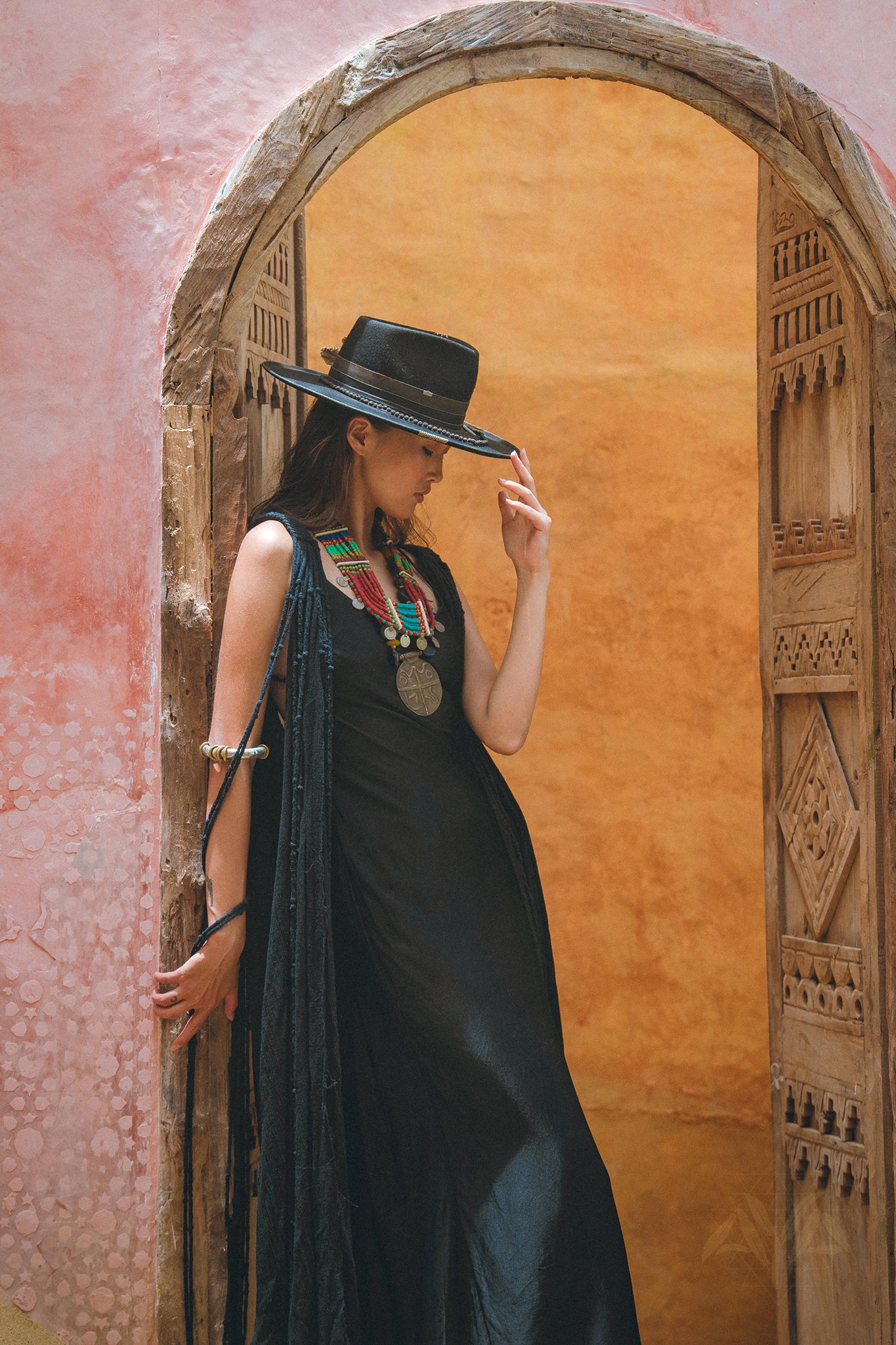 Step into the spotlight with the dramatic black cape dress from Aya Sacred Wear.